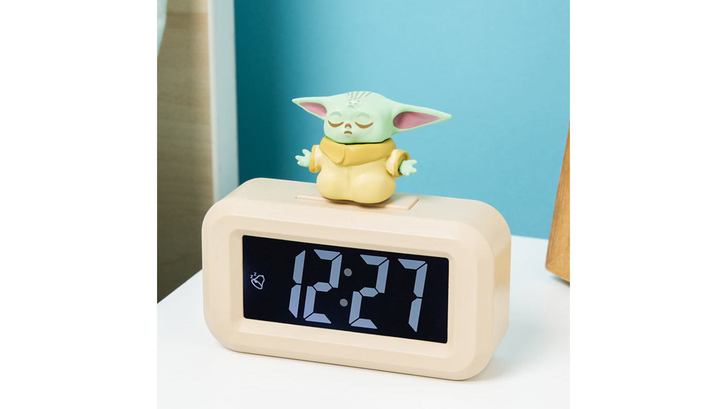 Grogu figurine on a beige Paladone Icon novelty alarm clock showing 12:27