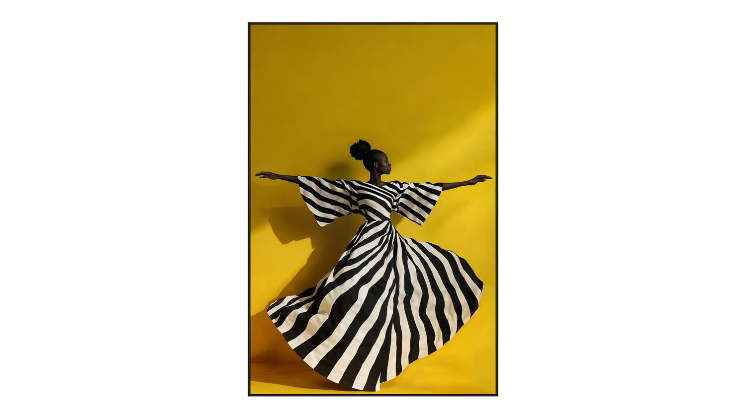 A full-length portrait of a person in a flowing black-and-white striped dress, against a vivid yellow background