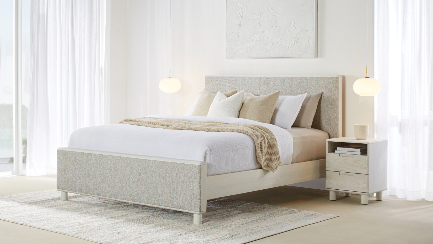 A contemporary Arlo king-size bed frame featuring a light grey textured fabric upholstered headboard and footboard