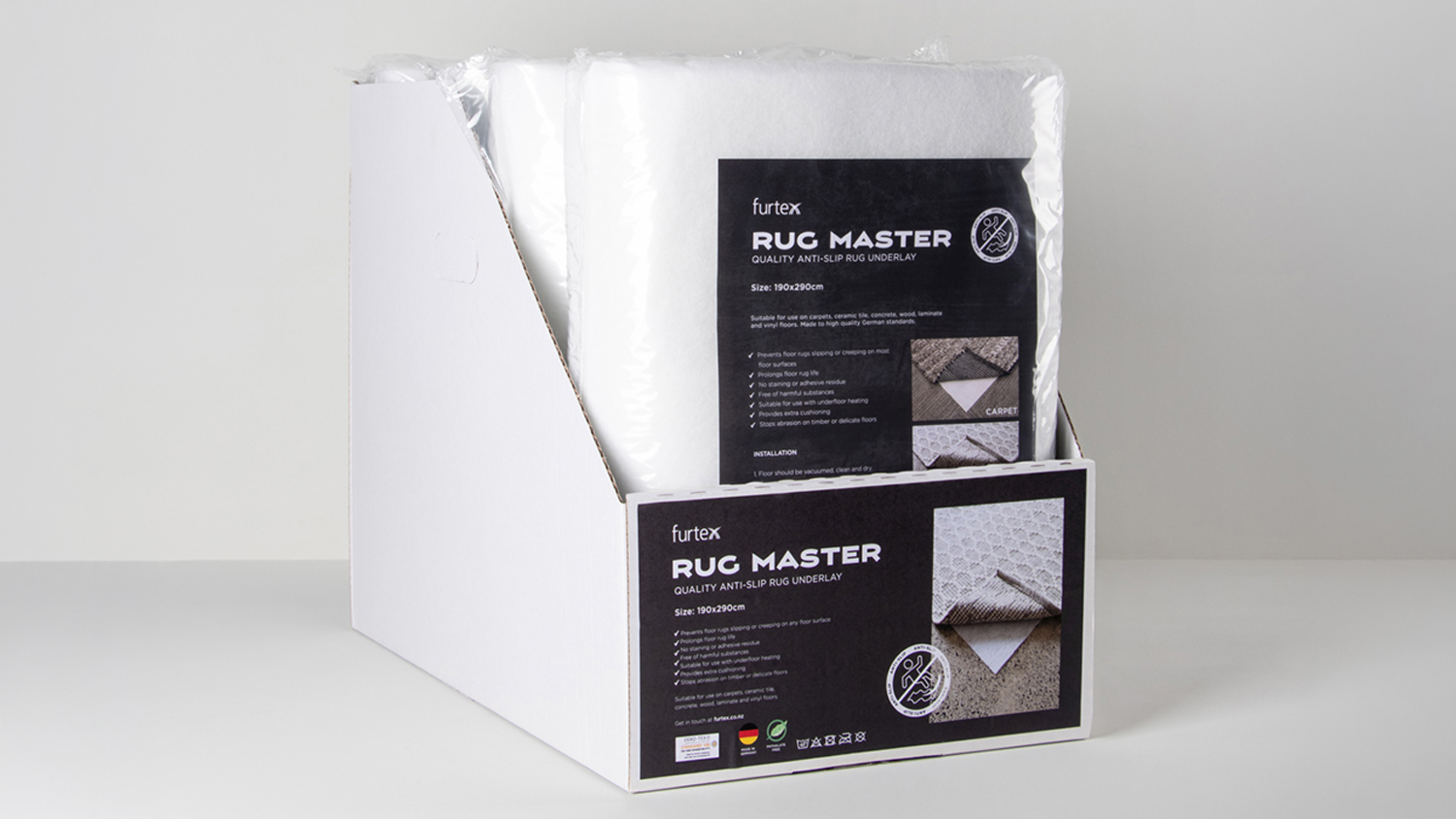 Retail display box containing a roll of white RugMaster Anti-Slip Underlay, highlighting compatibility details