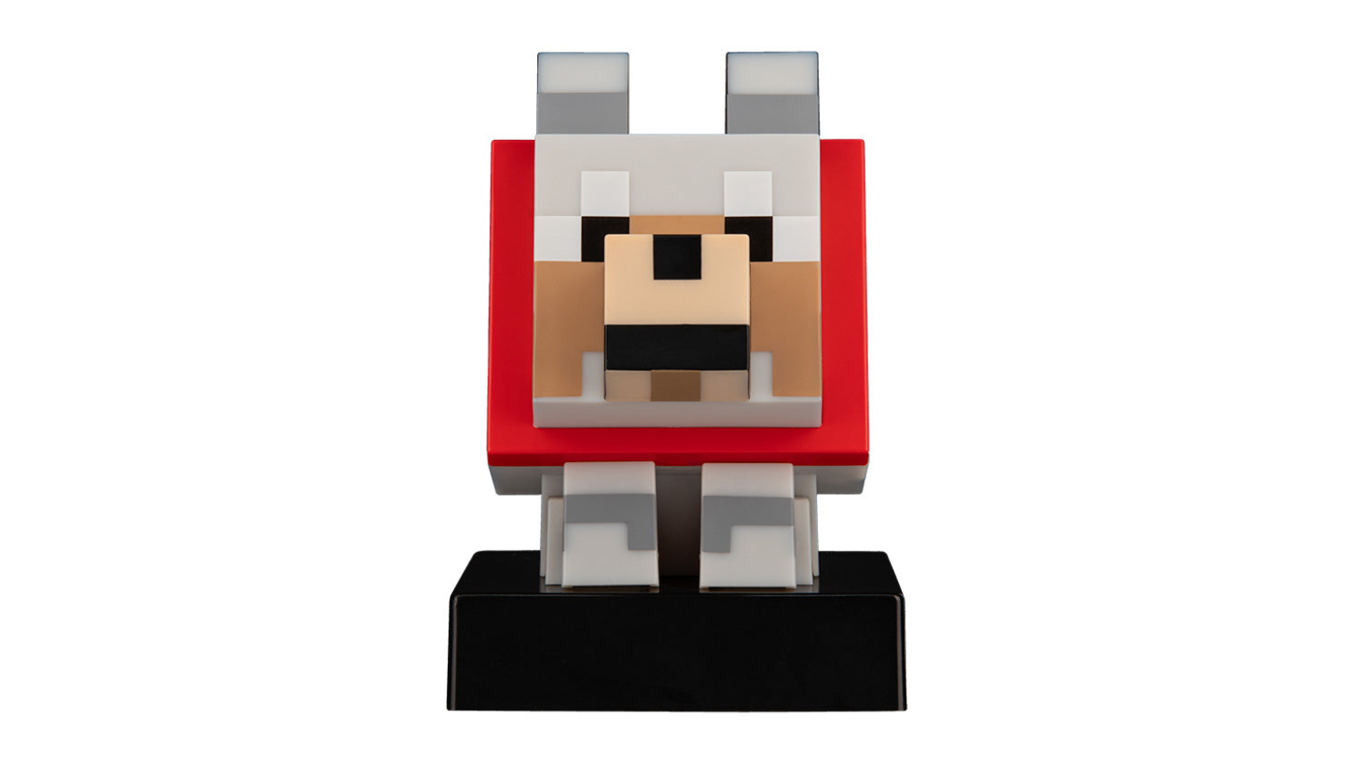 Front view of a block-style dog figure with a red body, square face, and grey ears, placed on a black base