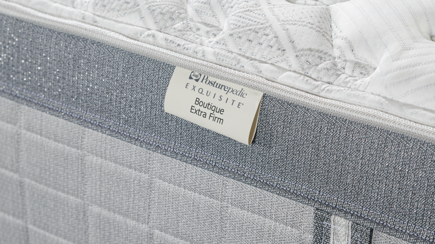 A close up view of the product's 'Boutique Extra Firm' tag