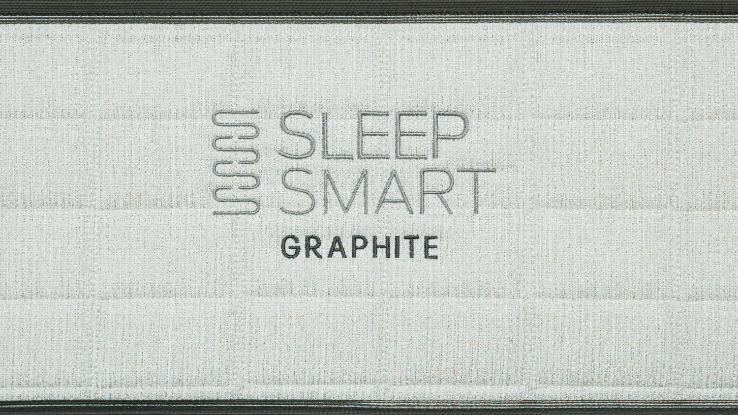Embroidered logo on the side of a Graphite Soft King Single Mattress, displaying the brand name and model