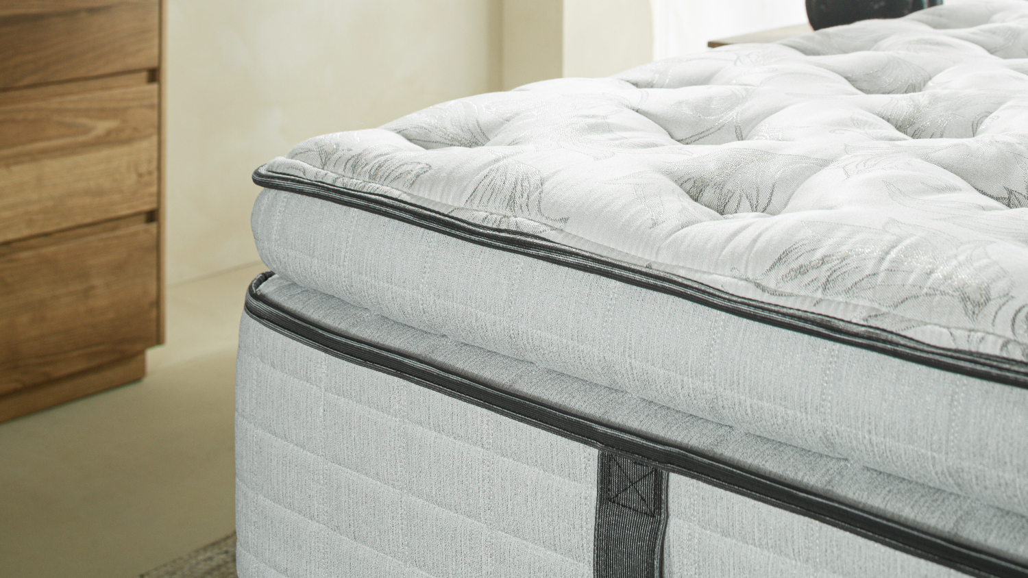 Side profile of the Graphite Medium mattress focusing on the thick comfort layer and piping