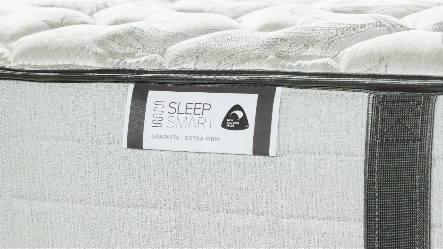 White quilted mattress with grey edge and Sleep Smart Graphite label on side panel