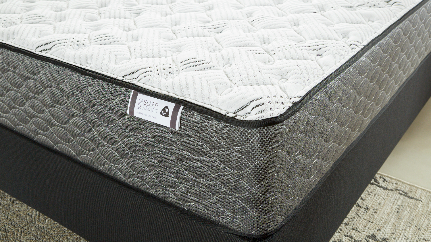 Grey and white quilted mattress a dark base with textured sides
