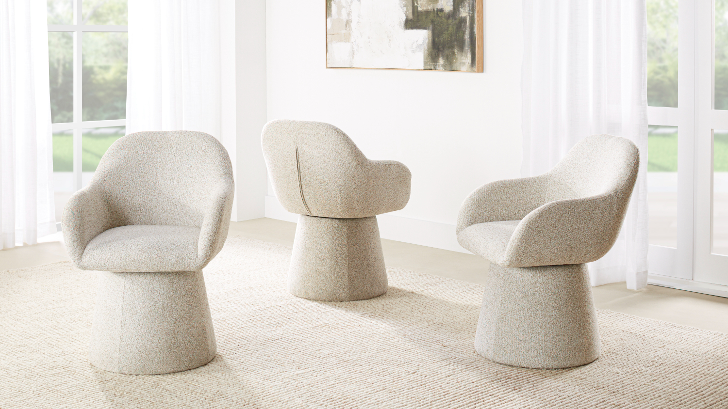 A view of three Carter Fabric Swivel Dining Chairs in Beige