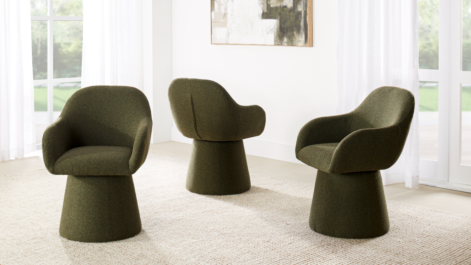 A view of three Carter Fabric Swivel Dining Chairs in Green
