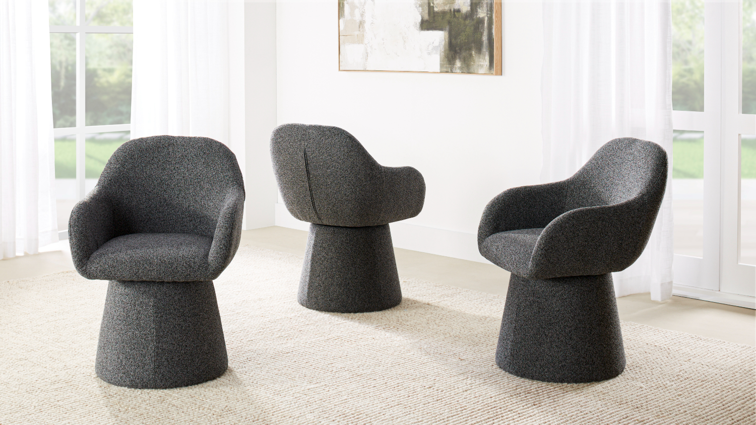 A view of three Carter Fabric Swivel Dining Chairs in Dark Grey
