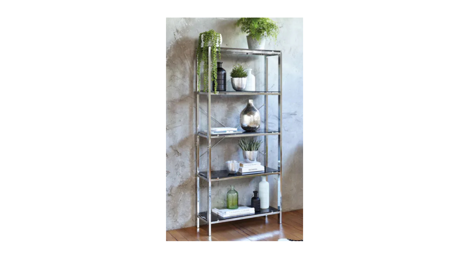 Decorative Arnoux 800W metal bookcase styled with potted plants, books, and vases against a textured wall in a modern interior