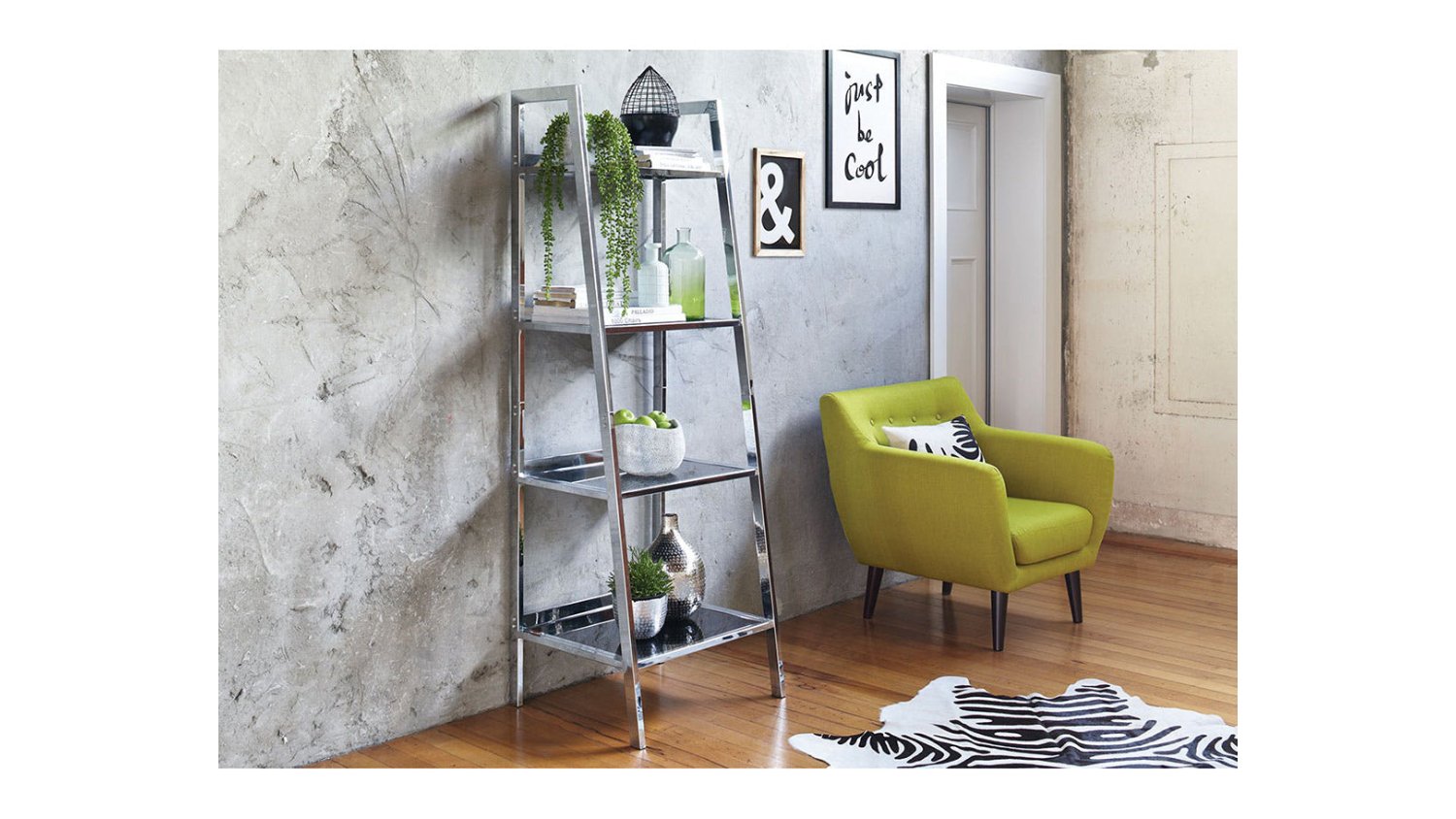 Modern room with Arnoux metal ladder shelf, plants and decor, beside green armchair on wood floor and zebra rug