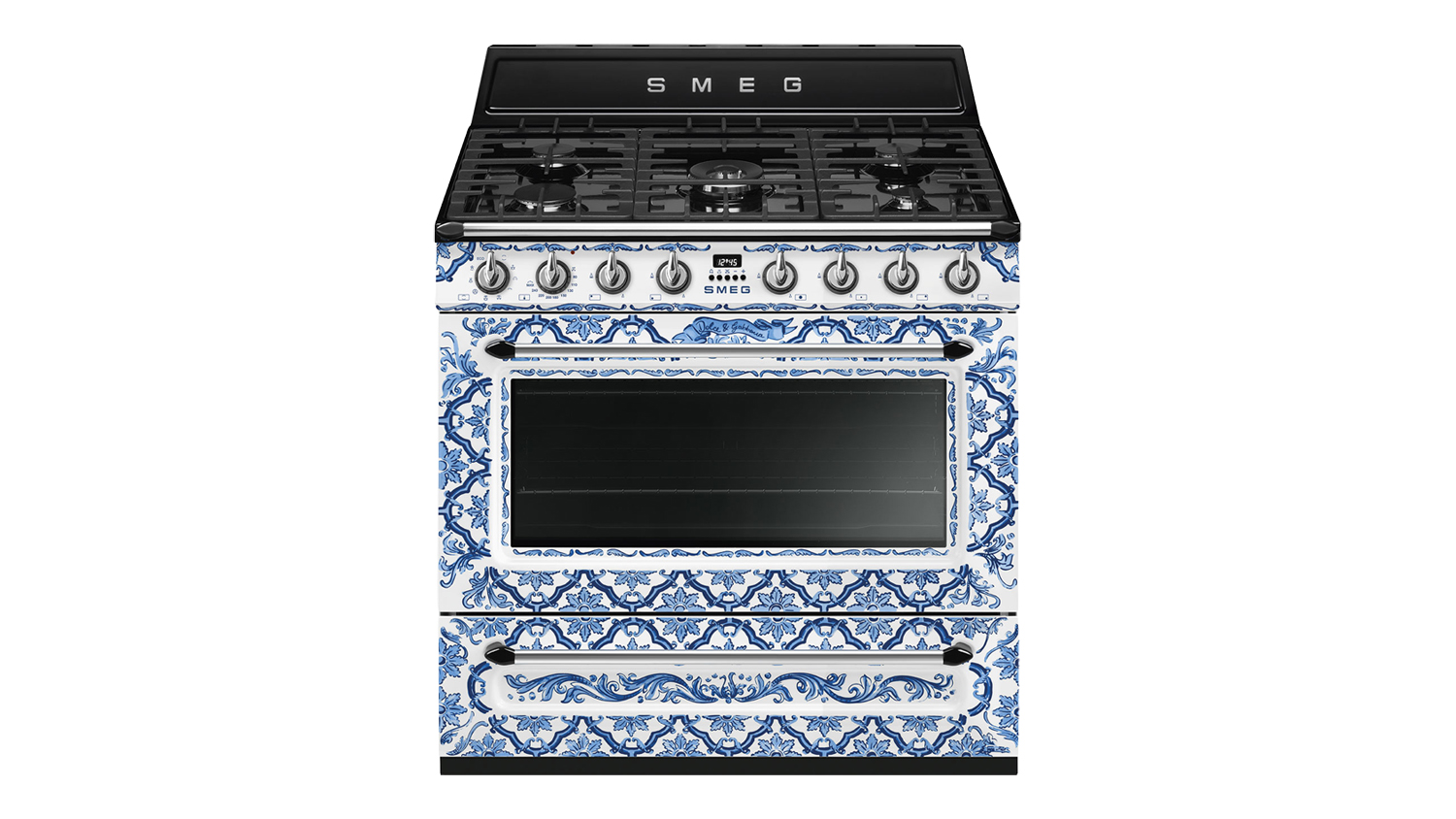 Front view of a Smeg cooker with a blue and white Dolce & Gabbana Mediterraneo pattern, black cooktop, and gold knobs