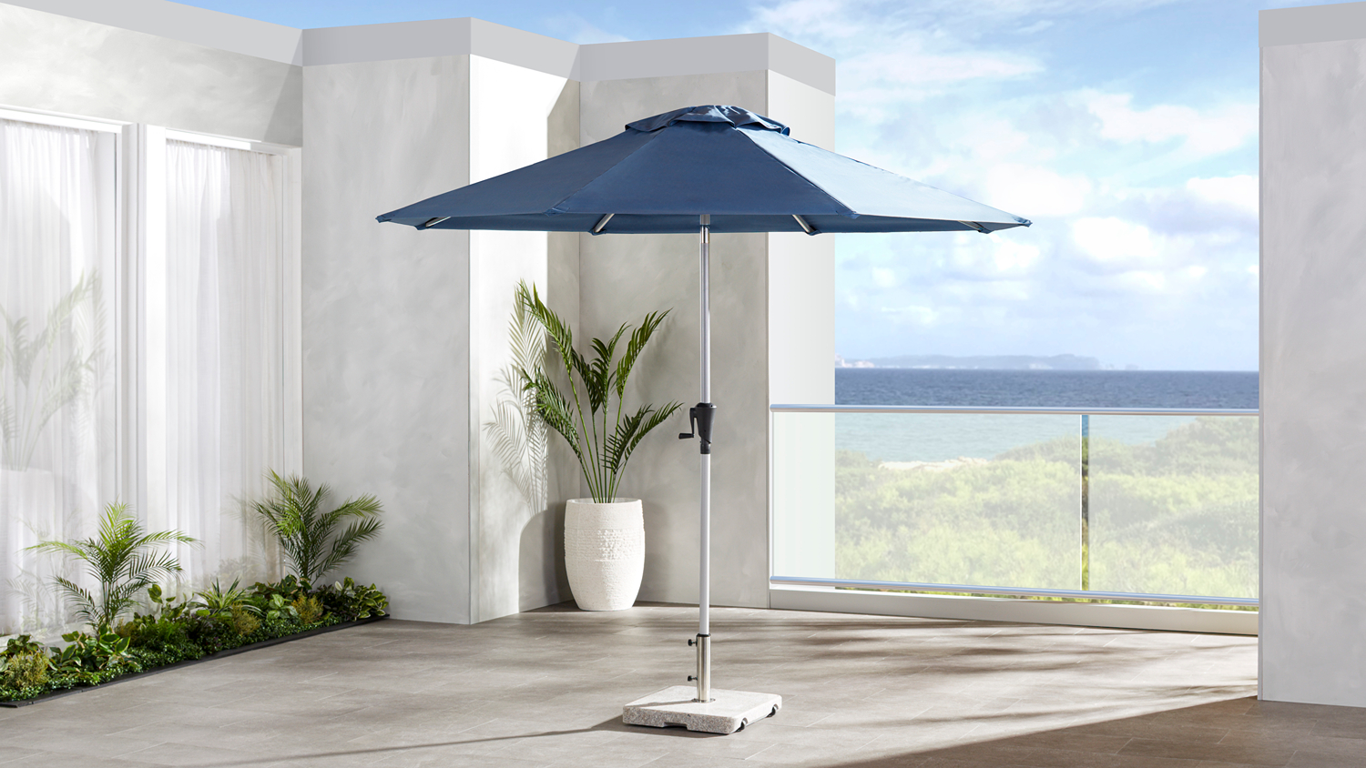 Waihi 2.7m outdoor umbrella with a dusky blue polyester canopy and aluminium centre pole, displayed open on a patio