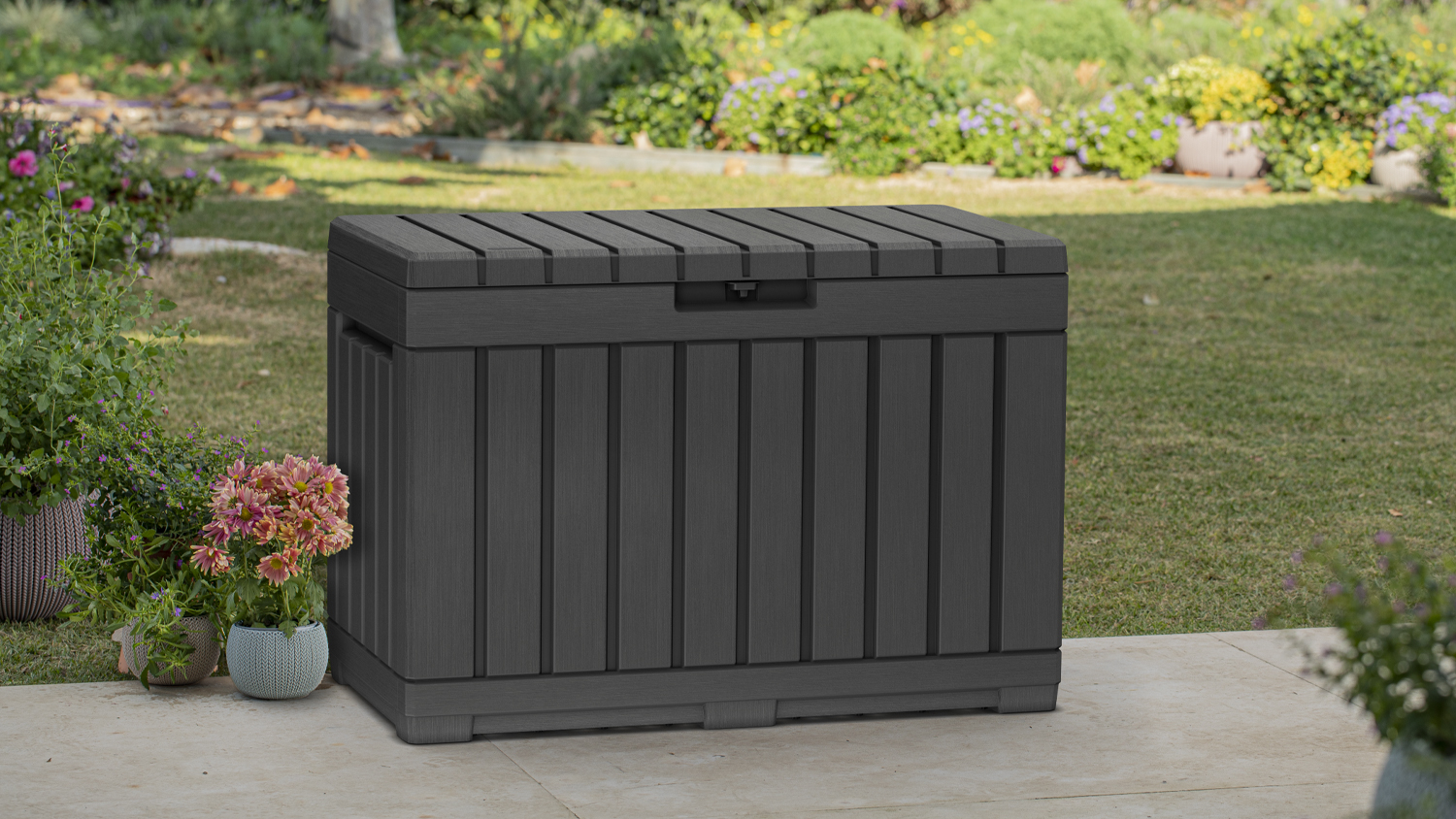 A Keter Kentwood Small Cushion Storage Box 190L in a sleek graphite colour