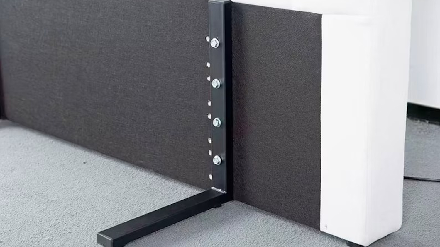 Close-up view of the Majestic Motion L-Shaped Headboard Bracket by Mlily installed behind a bed
