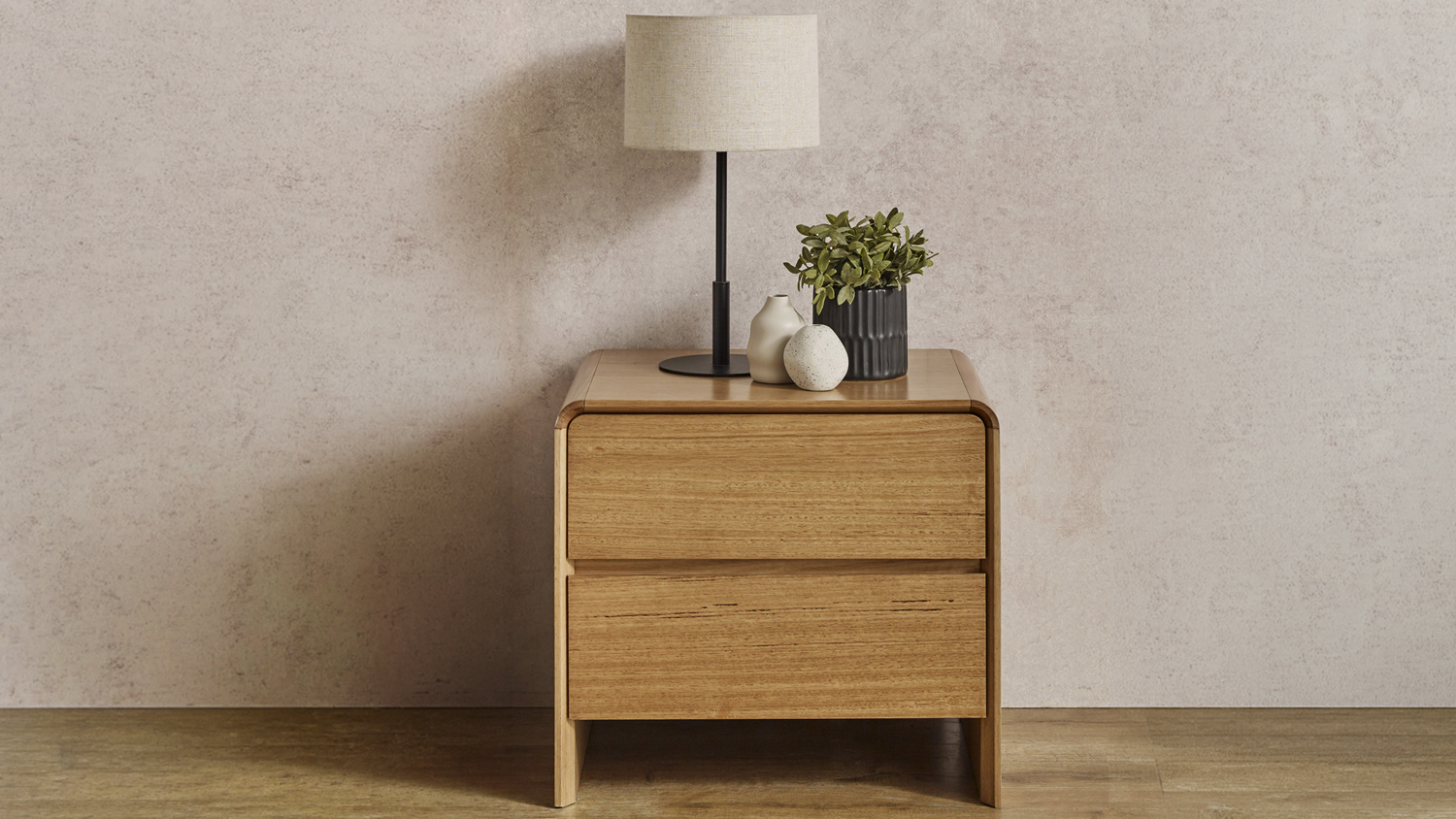 Cassie 2 Drawer Bedside Table featuring clean wooden drawers and minimalist decor items on the surface