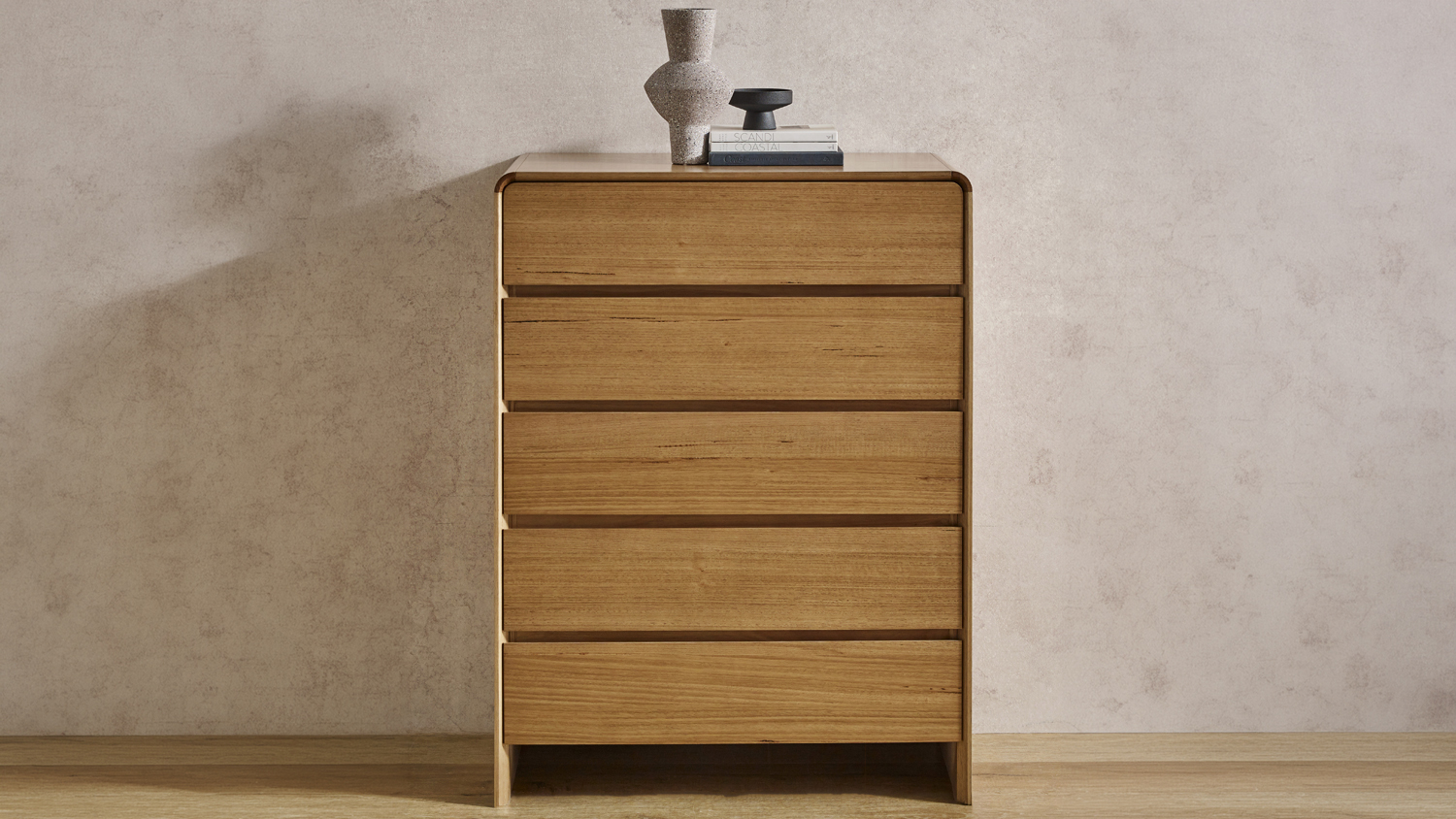 A wooden Cassie 5 Drawer Tallboy featuring five horizontal drawers and rounded top edges