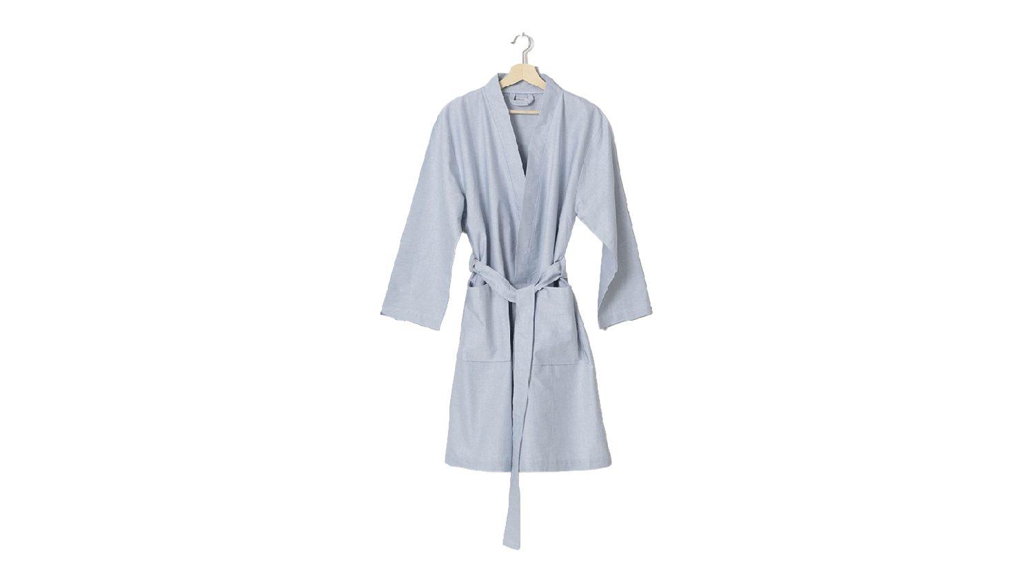 Light blue Baksana Billy bathrobe with a tie belt and front pockets, hanging on a wooden hanger