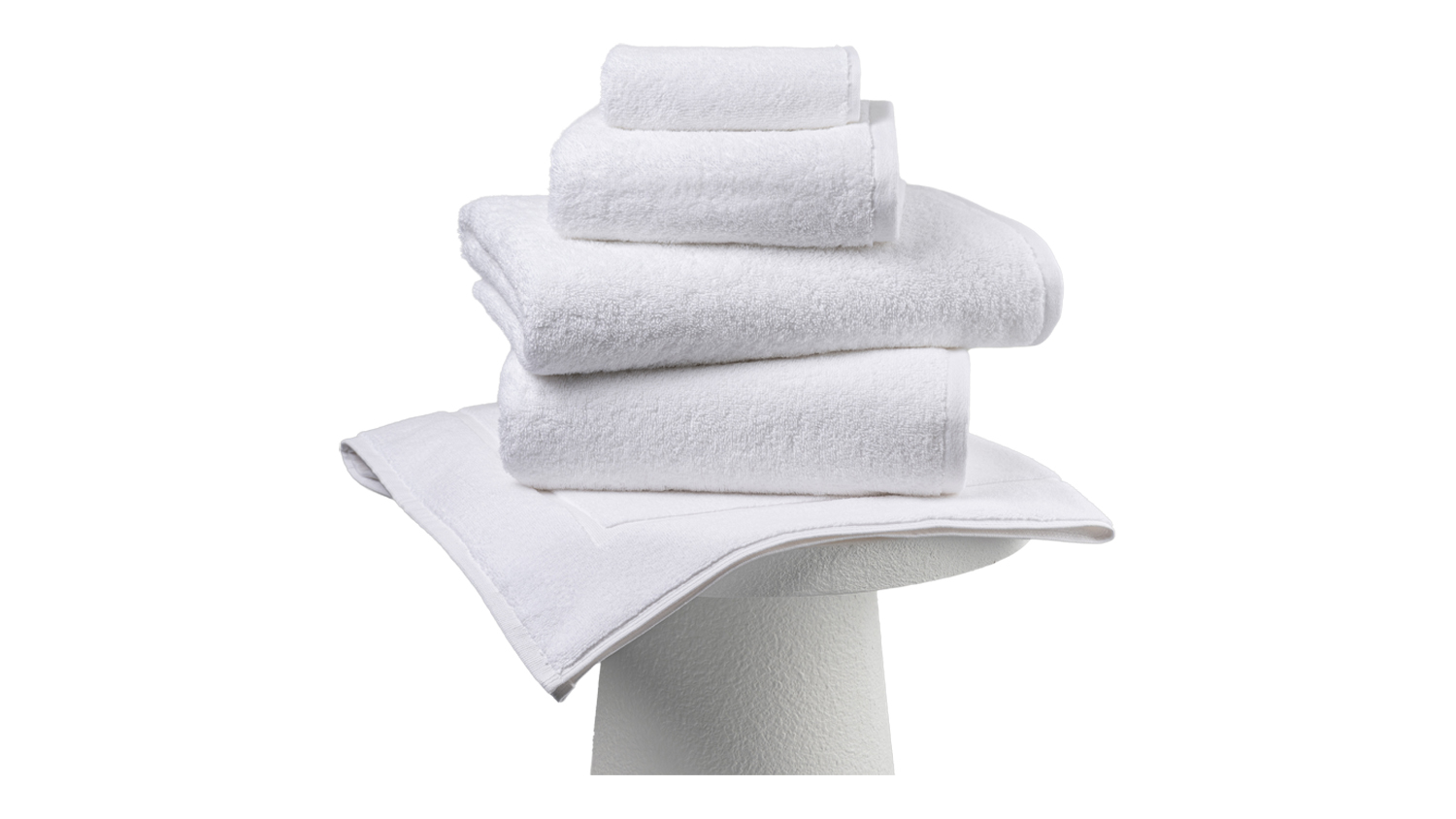 Arctic Baksana Bursa Turkish-Style Towel Set stacked on a pedestal, featuring a bath towel, hand towel, washcloth, and bath mat