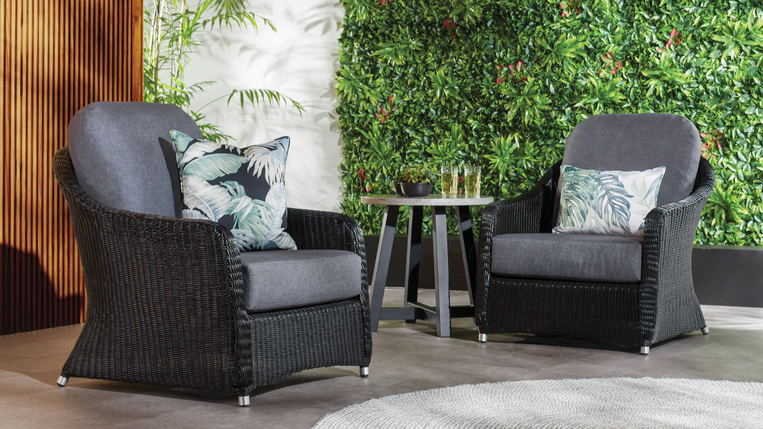 Marbella 3 Piece Outdoor Patio Setting featuring two woven synthetic wicker-style armchairs and a round side table