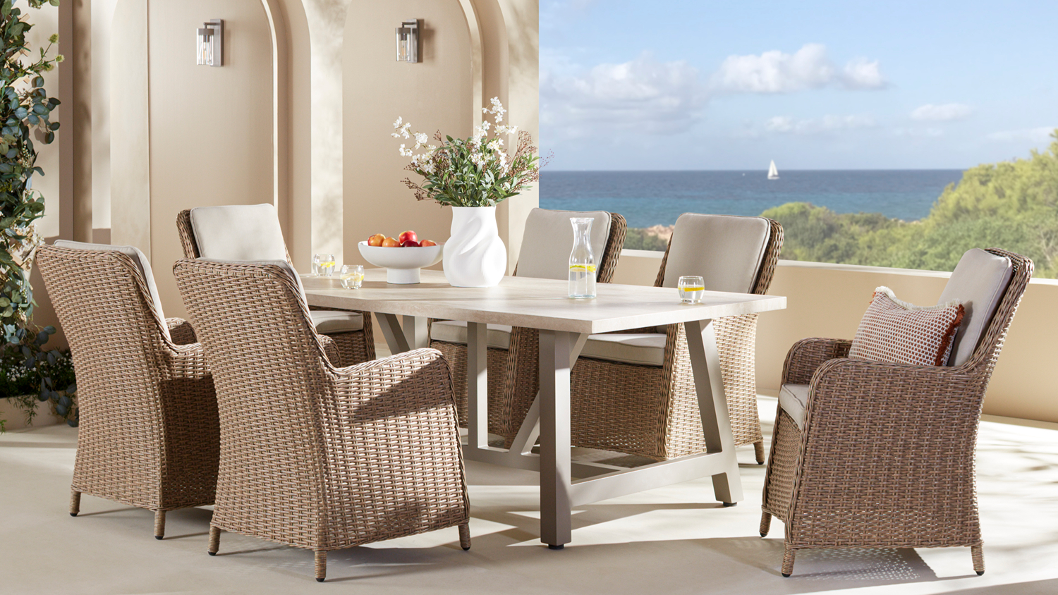 Savannah Outdoor Dining Suite featuring a rectangular dining table and six woven synthetic wicker-style dining chairs