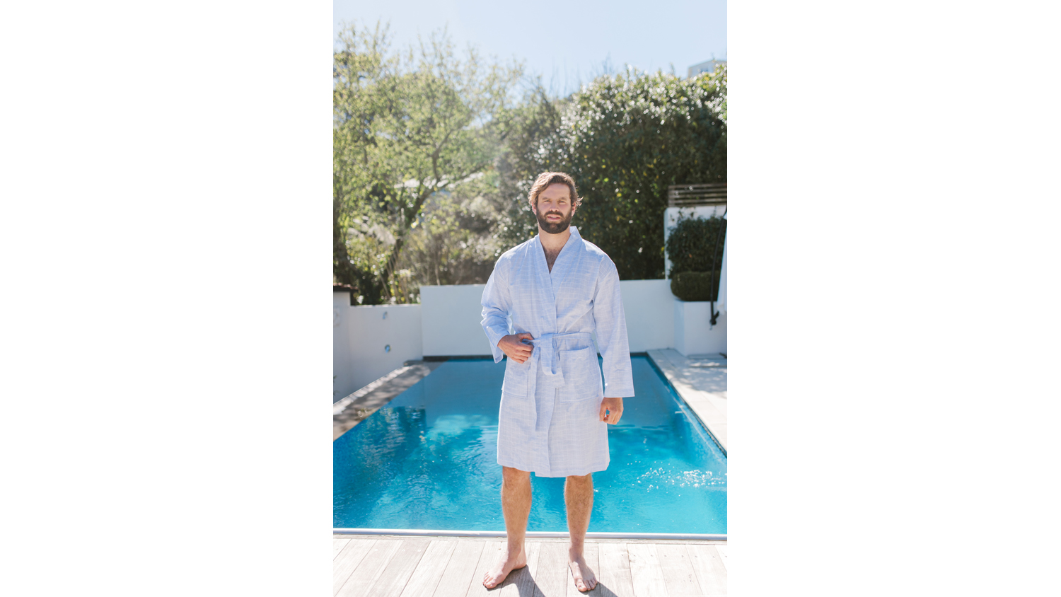 Baksana James Bath Robe in light blue check pattern, shown on a standing model, highlighting the shawl collar