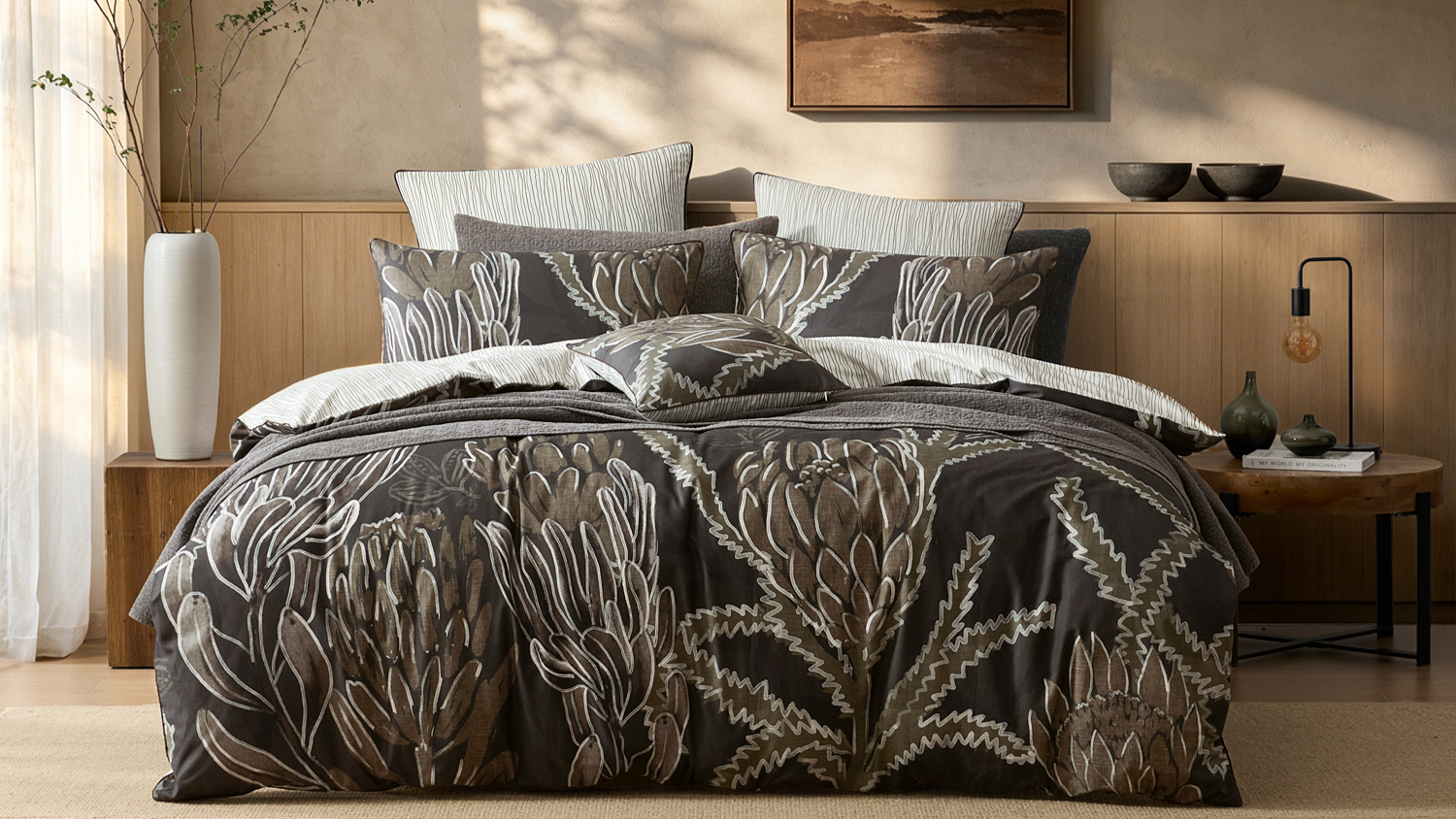 Kalina Chocolate duvet cover set by Logan & Mason featuring a bold botanical protea print on a modern bed