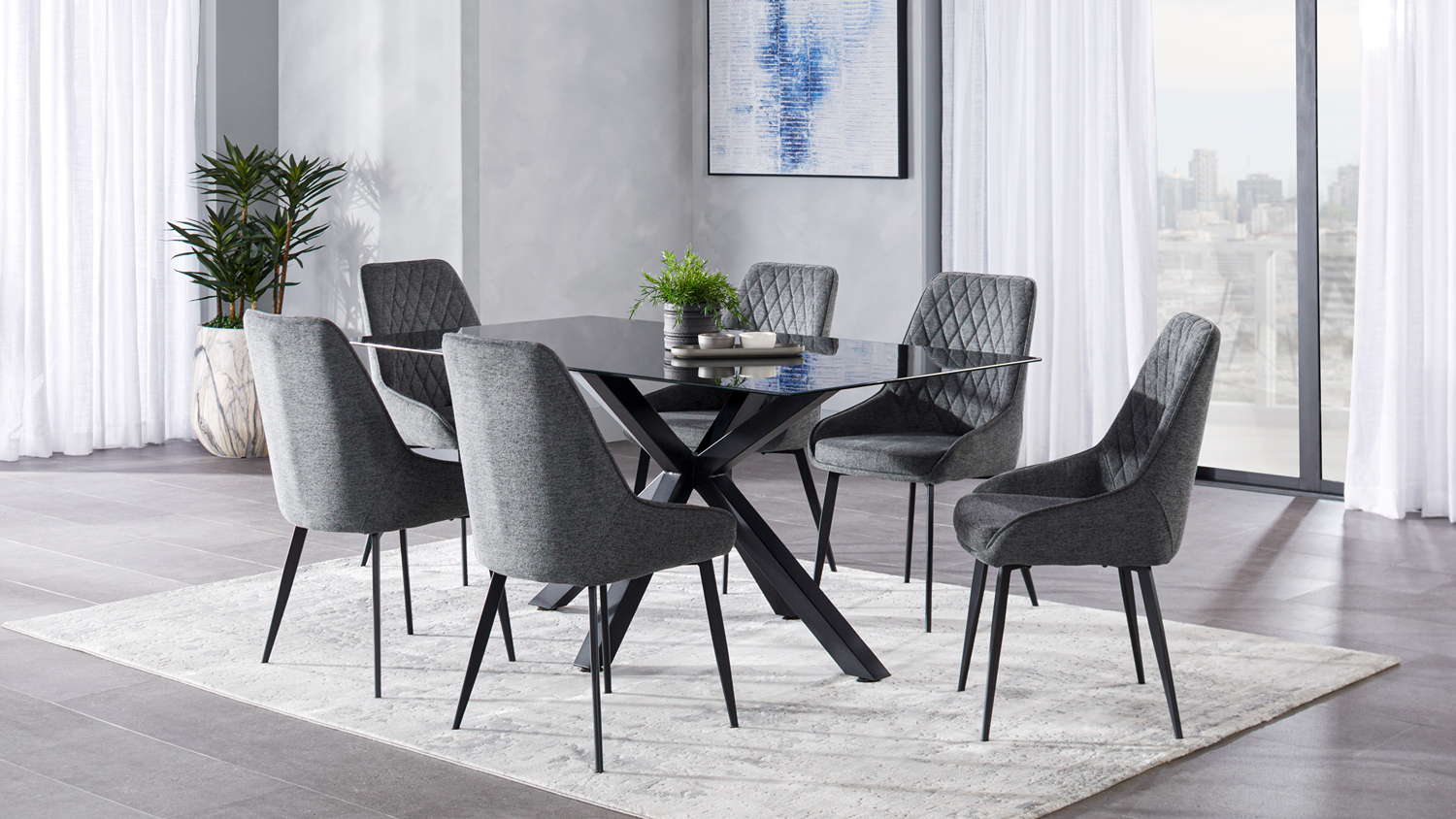 Otago 7-piece dining set with a black glass table and six grey fabric upholstered chairs angled in a room
