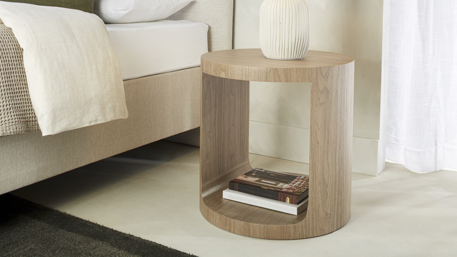 Zaida Bedside Table with a rounded open-frame design and natural wood-grain finish