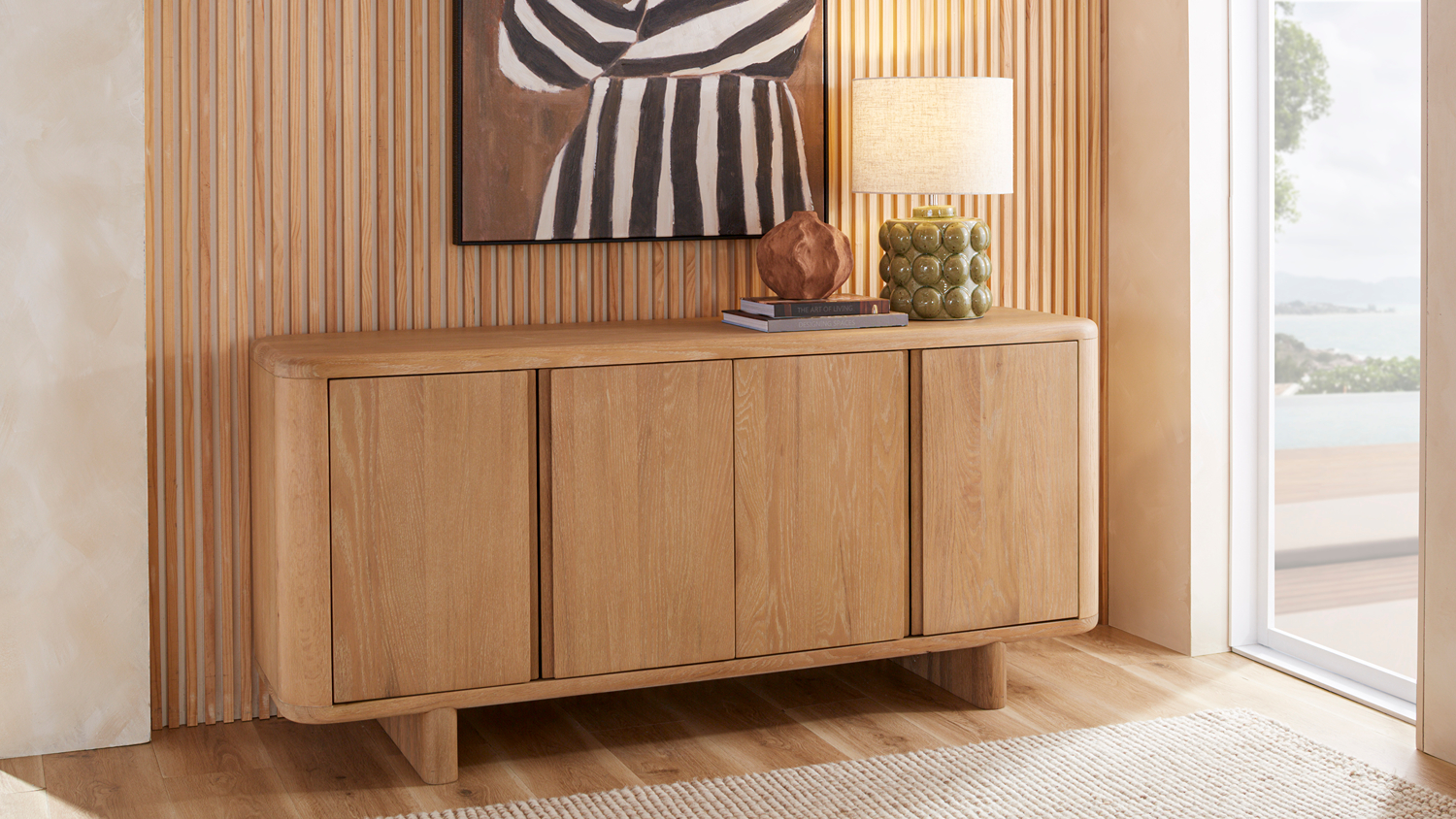 Front view of the Oxford 1400mm Buffet Table in light oak showing closed wooden doors and rounded edges