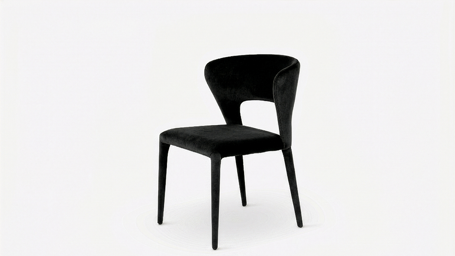 Angled view of the Pitcher Fabric Dining Chair in black upholstery, featuring a padded seat