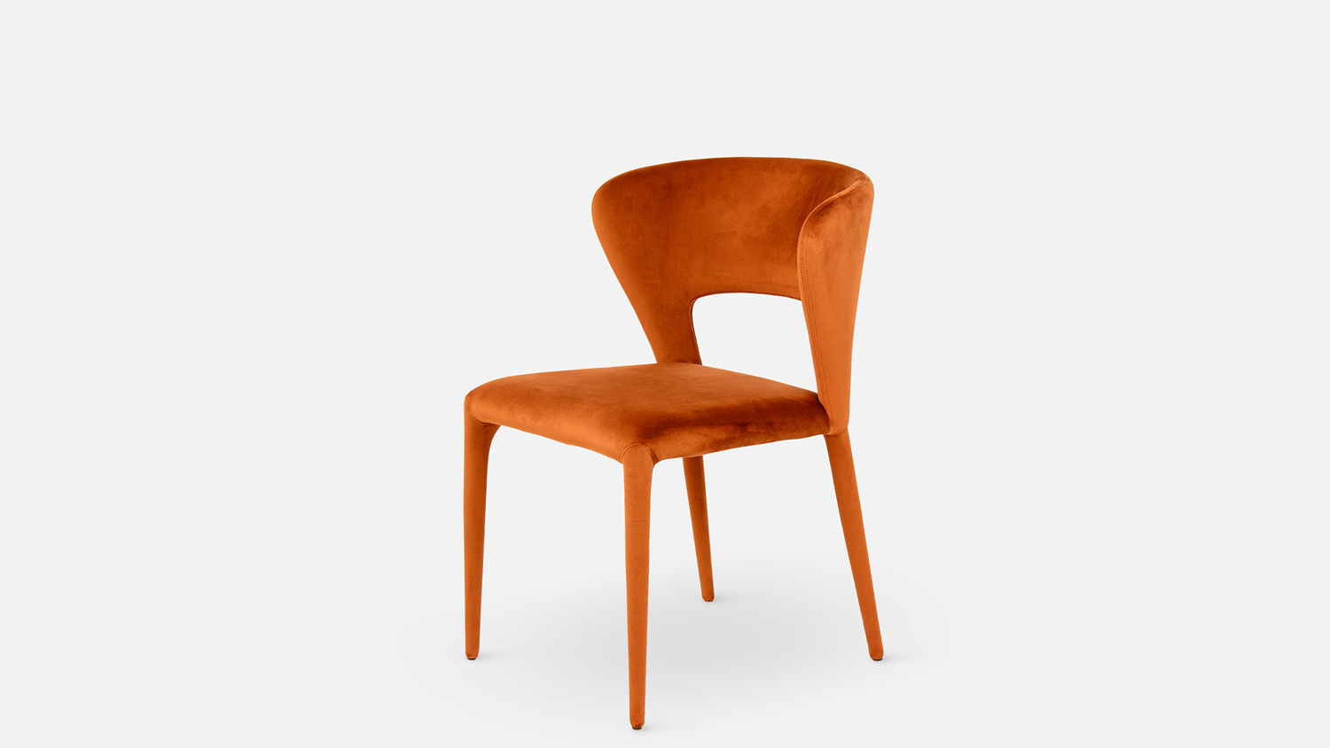 Angled view of the Pitcher Fabric Dining Chair in copper upholstery, featuring a padded seat