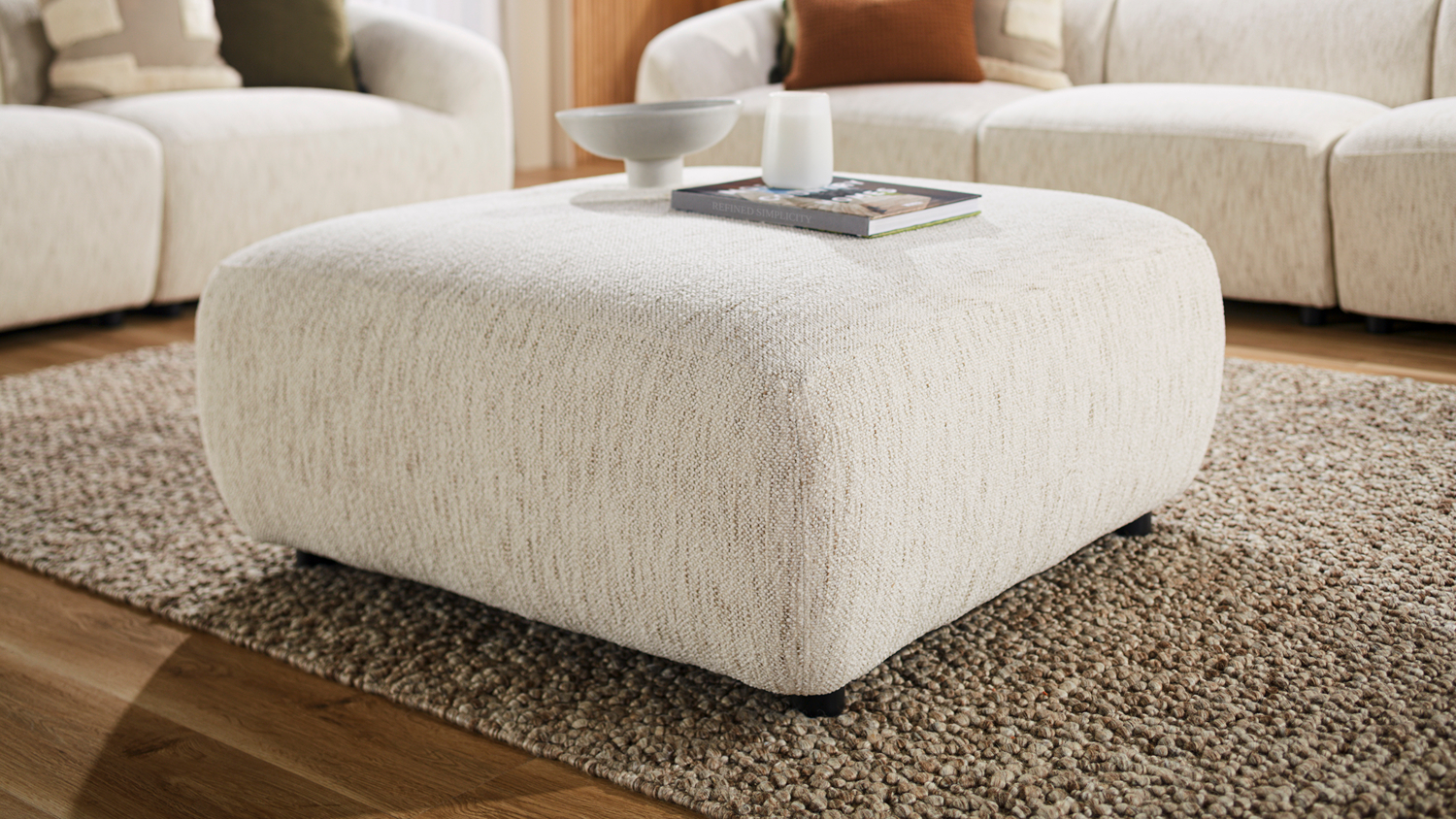 Villa Fabric Modular Ottoman in Optical styled on a rug in a modern living room setting