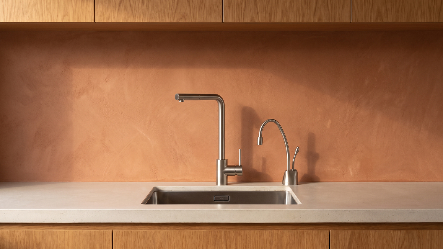 Front view of the InSinkErator ChillTap Chilled Filtered Side Tap mounted over a sleek kitchen sink