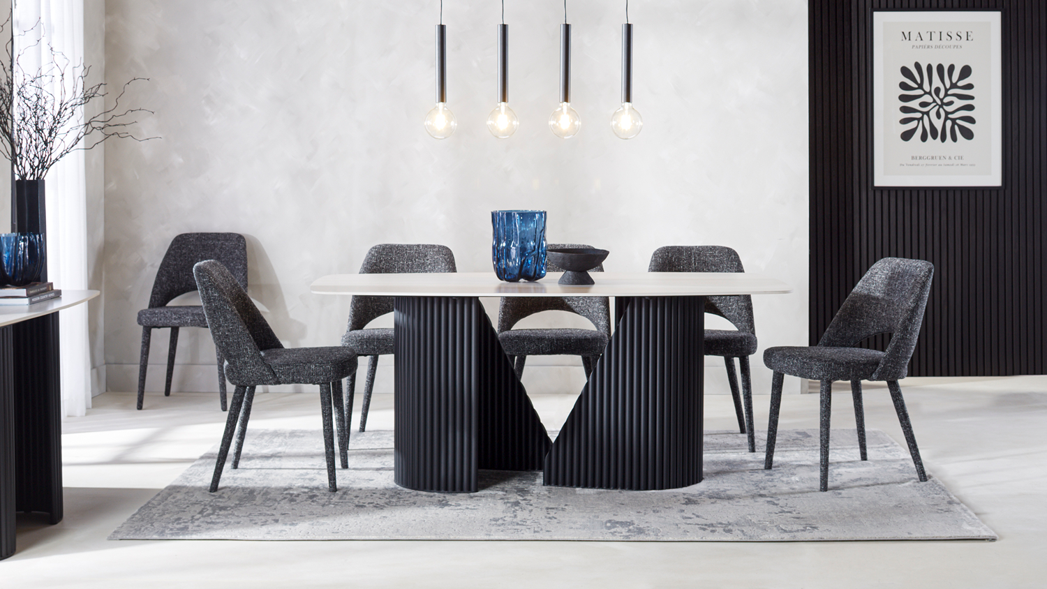Direct eye-level shot of Marsden Dining Suite showing sculptural black fluted table base