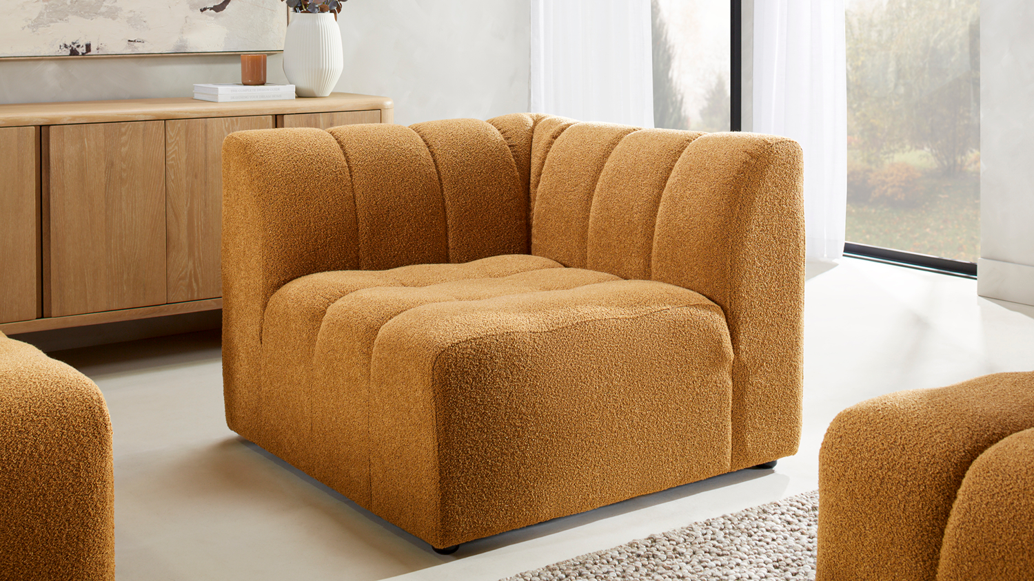 Modern Louisiana channeled bouclé corner chair piece in a bright living room setup