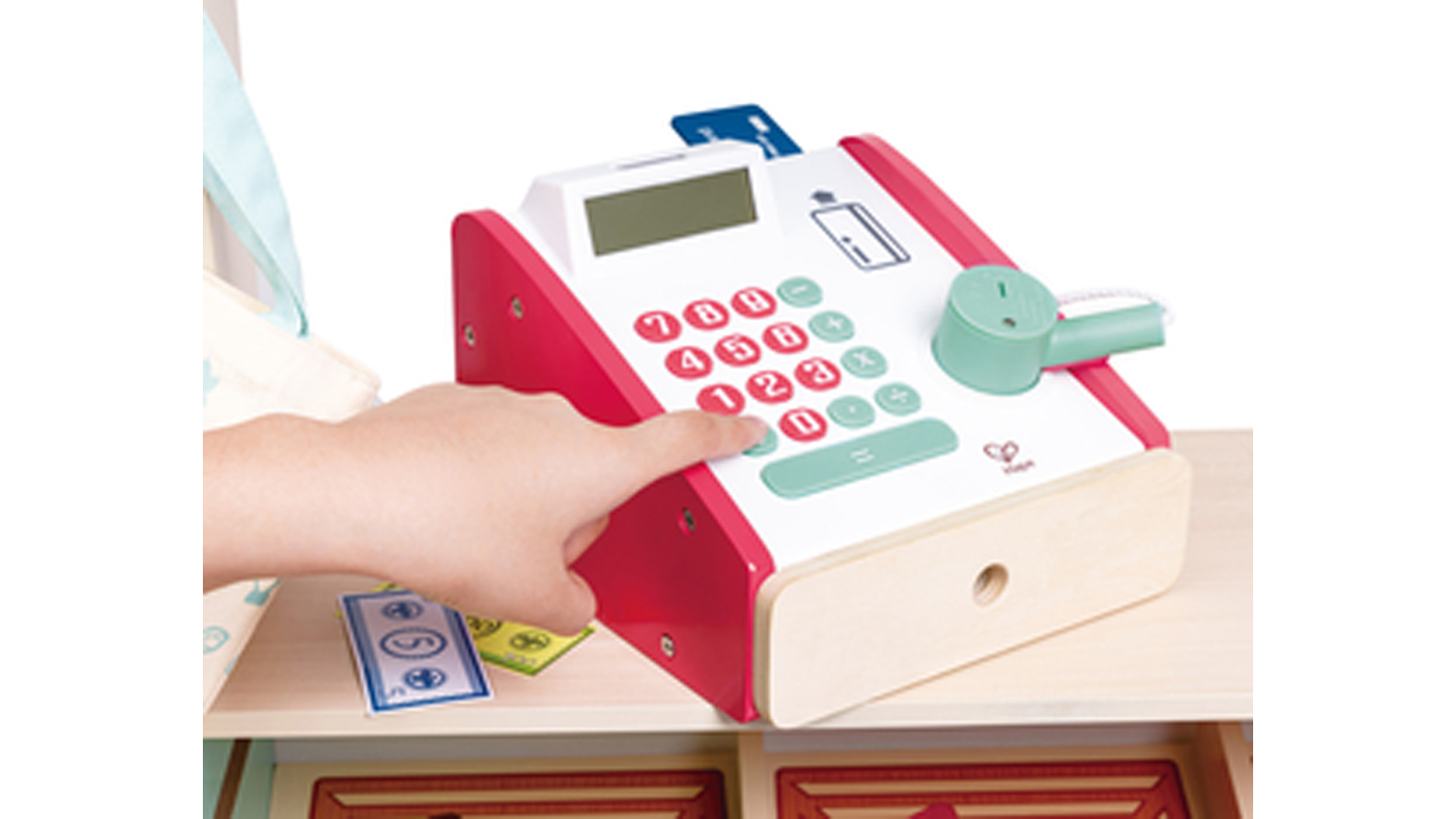 Close-up of the toy cash register showing buttons, display screen, cash drawer, and card payment accessory